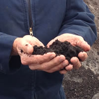 hands holding soil